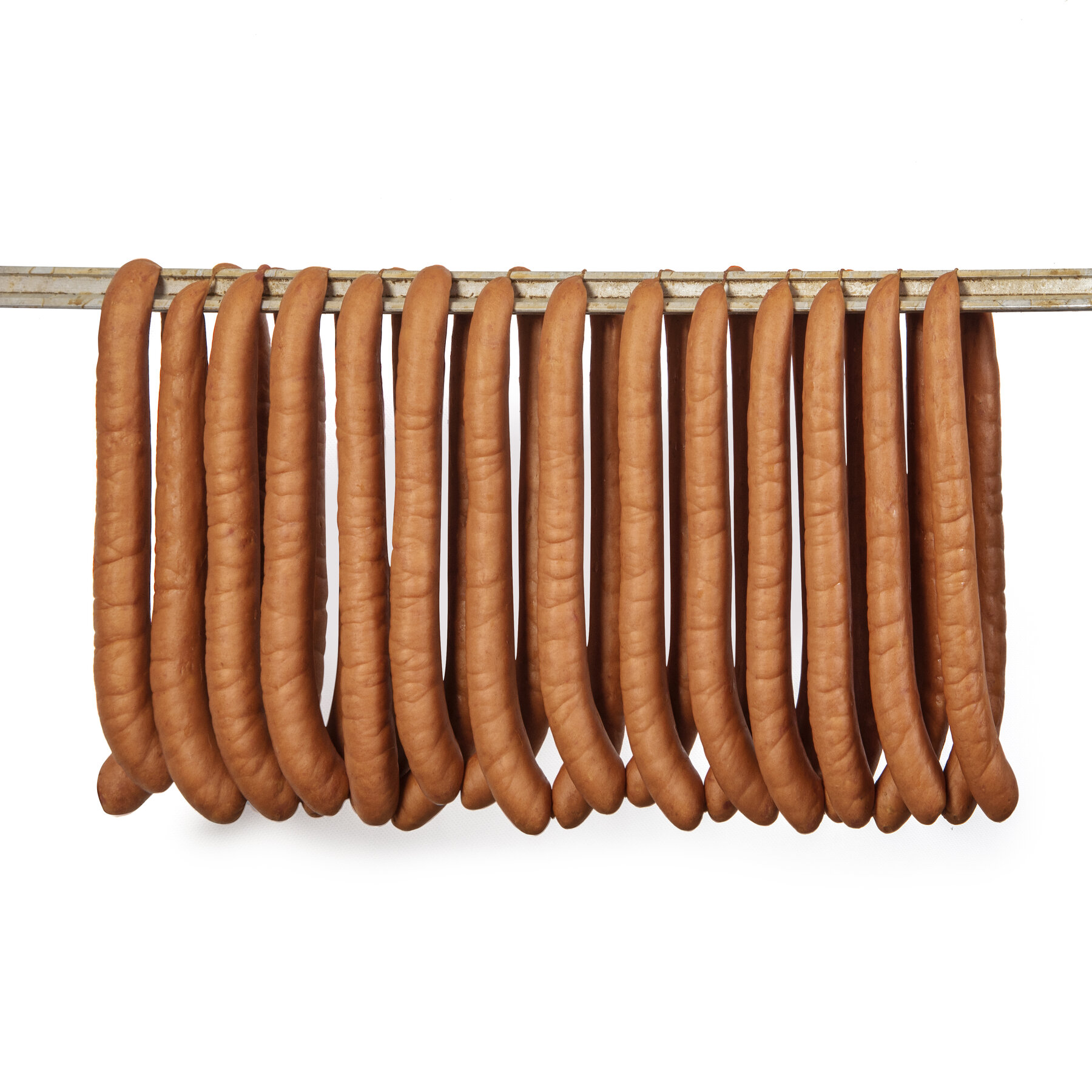 Freshly smoked Meat Mania sausages hanging on the rack